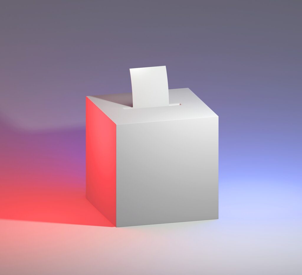 valkoinen äänestyslaatikko, jonka suulla on valkoinen äänestyslippu, taustaväreinä violetin eri sävyt